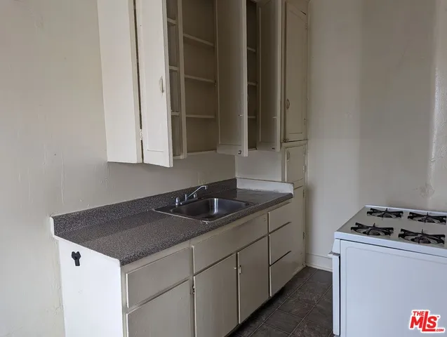 a kitchen with a sink and cabinets