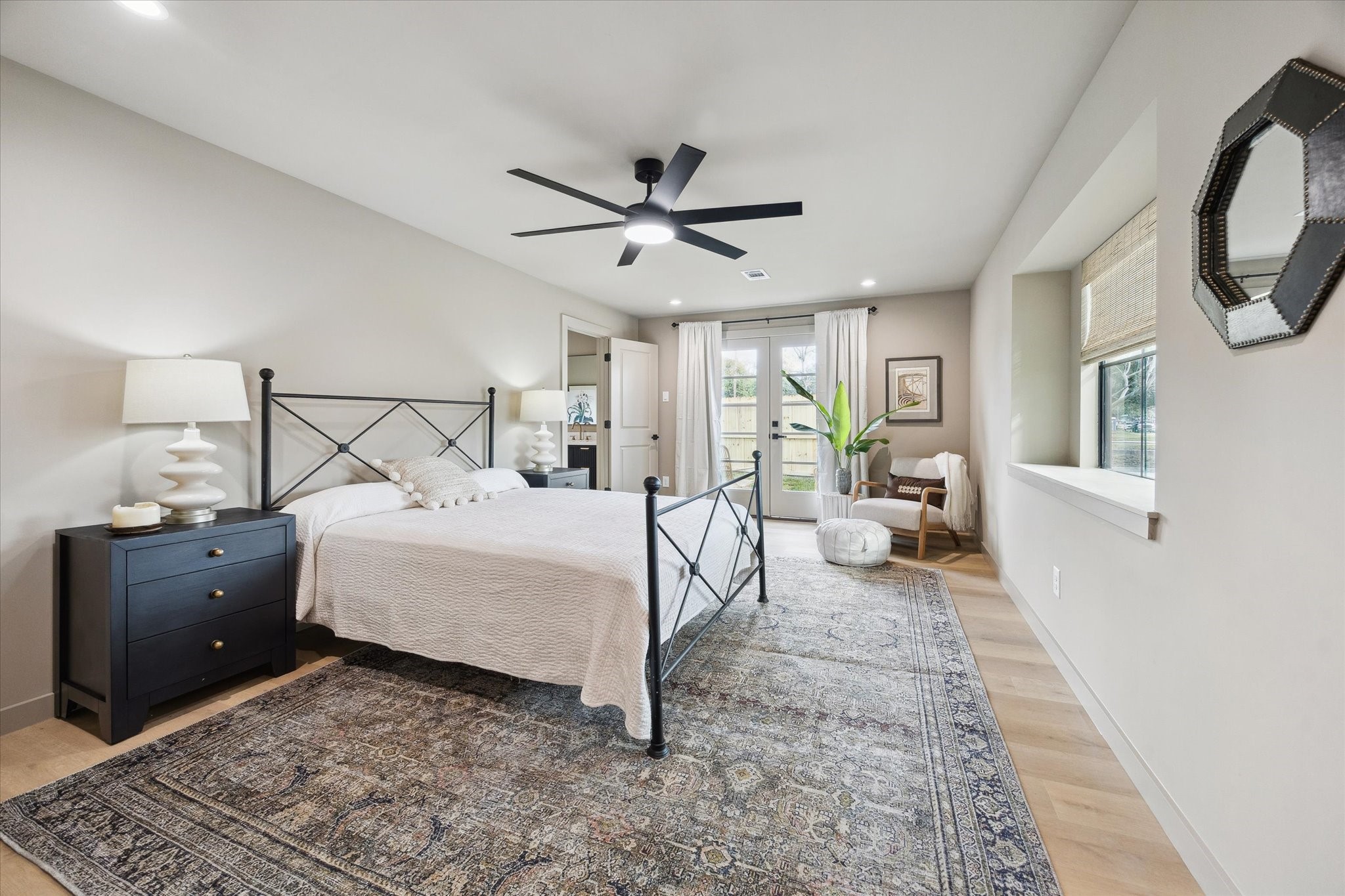 10402 Raritan Drive Houston, TX 77043 - Photo 14 of 27 a bedroom with a large bed and a chandelier