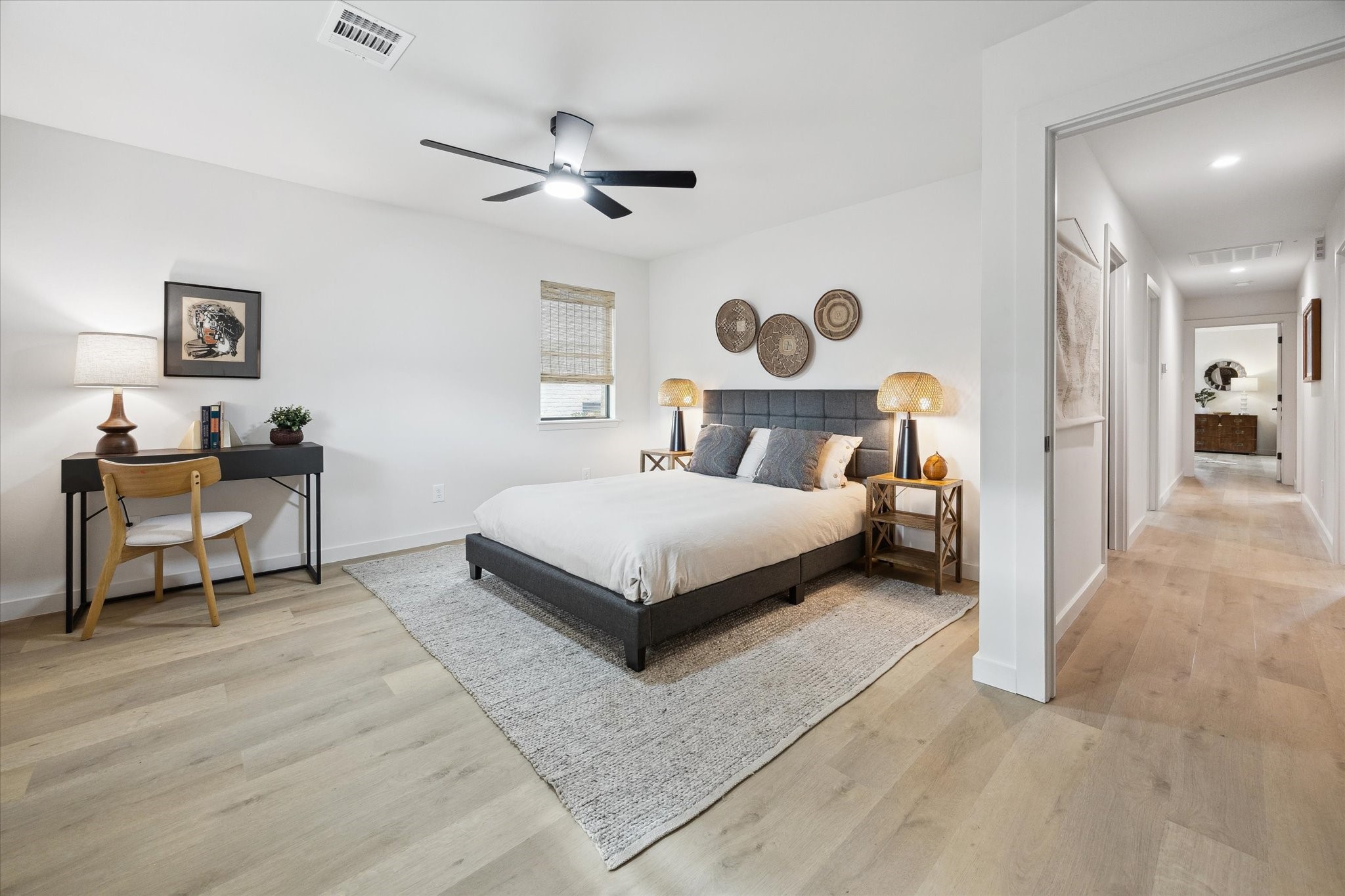 10402 Raritan Drive Houston, TX 77043 - Photo 19 of 27 a bedroom with a bed and a chandelier