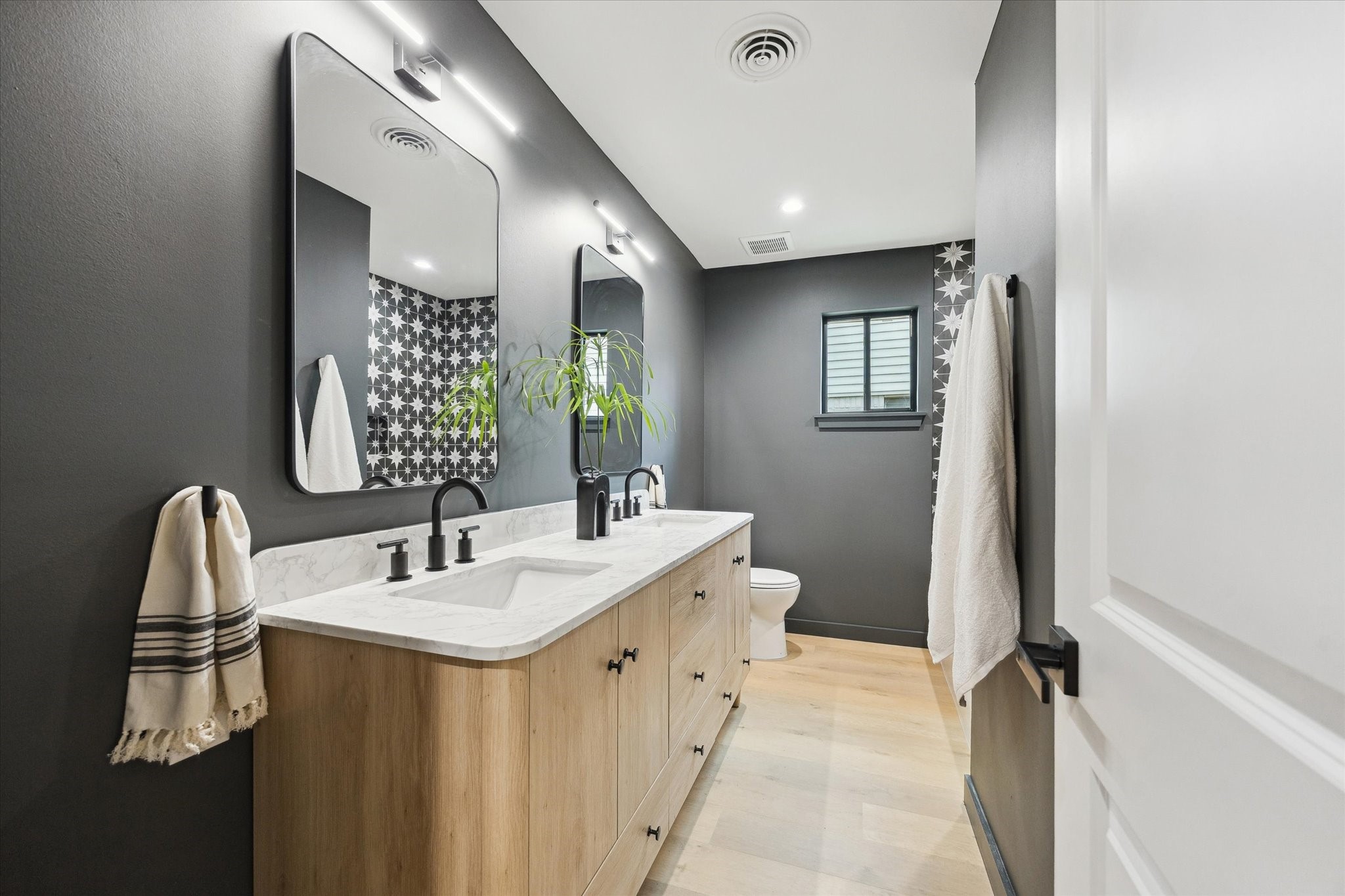10402 Raritan Drive Houston, TX 77043 - Photo 20 of 27 a bathroom with a sink and a mirror