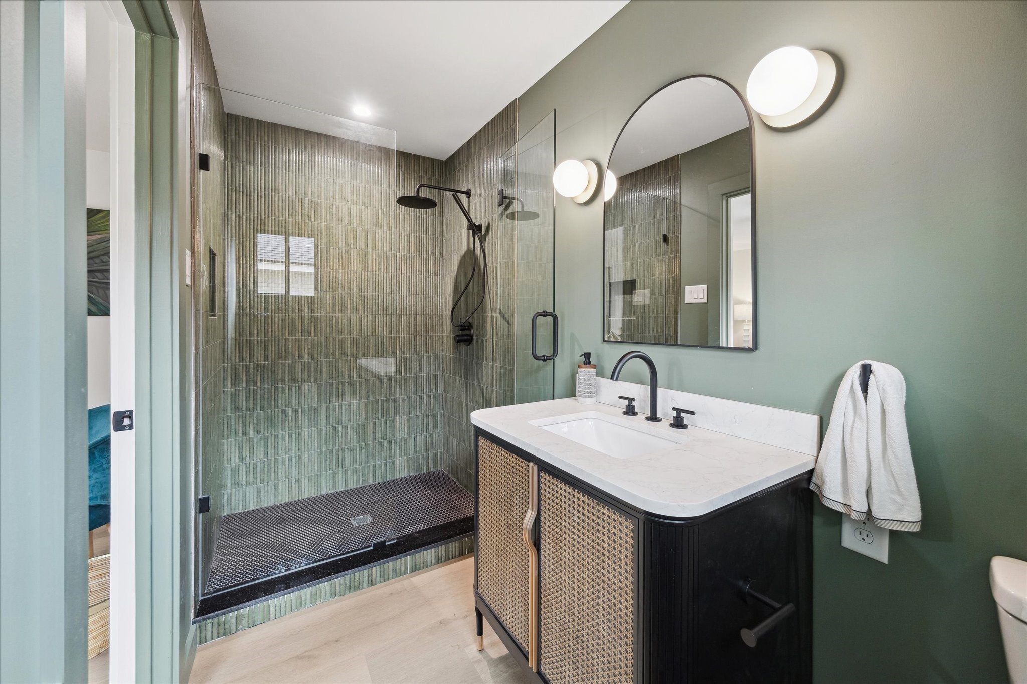 10402 Raritan Drive Houston, TX 77043 - Photo 23 of 27 a bathroom with a sink mirror and a shower