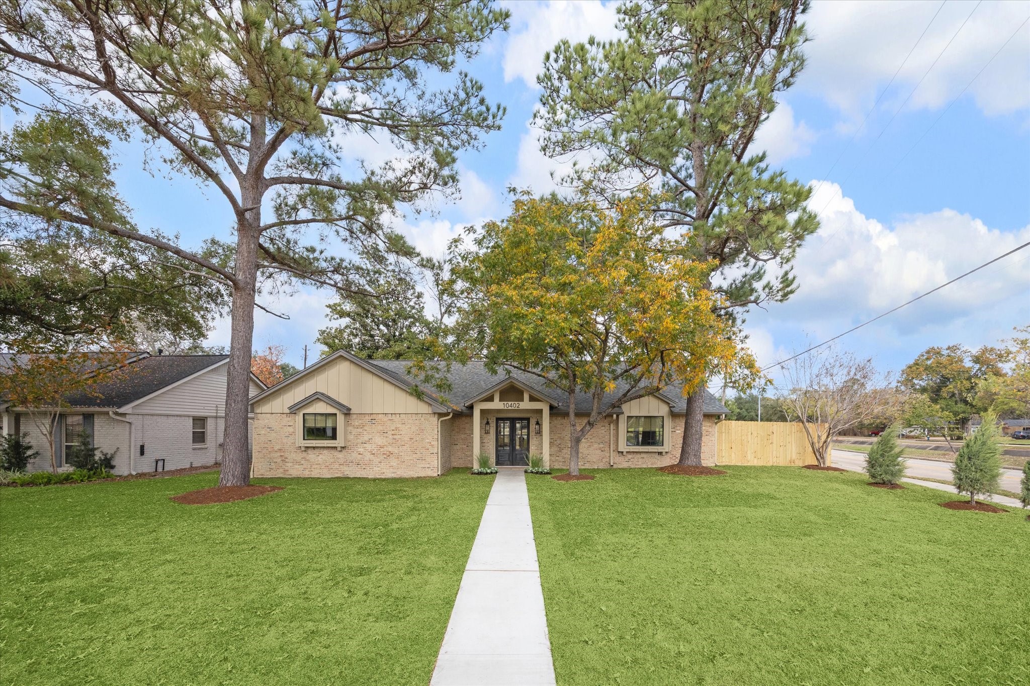 10402 Raritan Drive Houston, TX 77043 - Photo 24 of 27 a front view of house with yard and green space