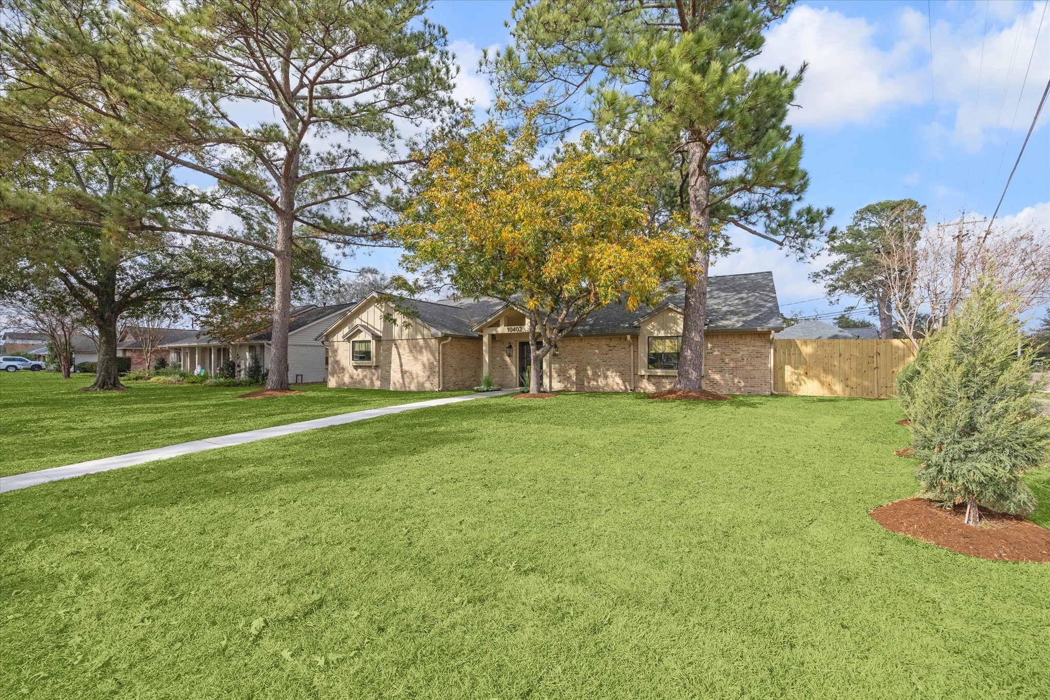 10402 Raritan Drive Houston, TX 77043 - Photo 26 of 27 a view of a house with a big yard and large trees