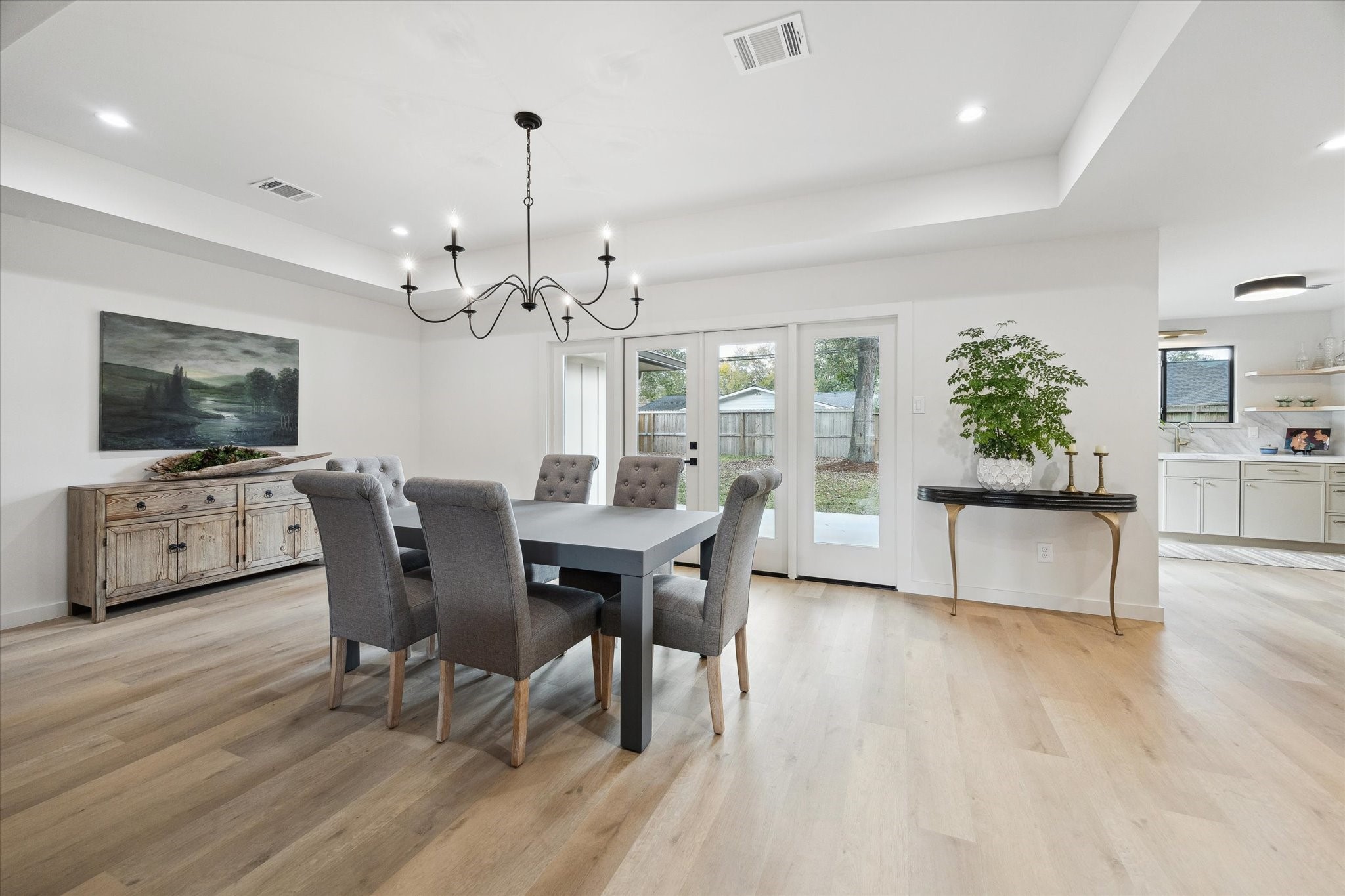 10402 Raritan Drive Houston, TX 77043 - Photo 7 of 27 a view of a dining room with furniture wooden floor and chandelier