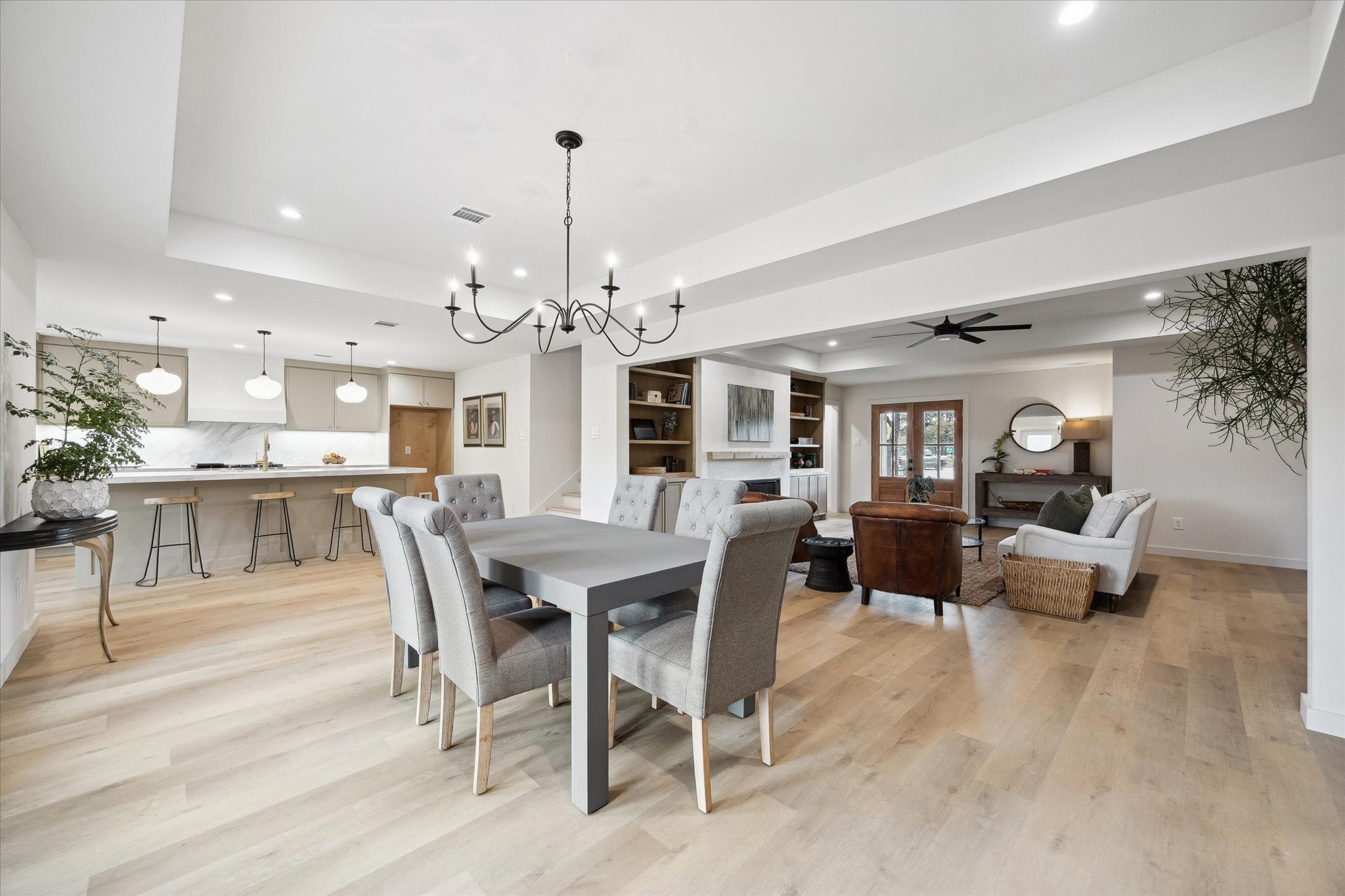 10402 Raritan Drive Houston, TX 77043 - Photo 8 of 27 a view of a dining room and livingroom with furniture wooden floor a chandelier