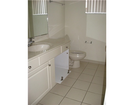 4262 Coventry Pointe Way Lake Worth, FL 33461 - Photo 9 of 12 a spacious bathroom with a granite countertop sink a toilet and a mirror