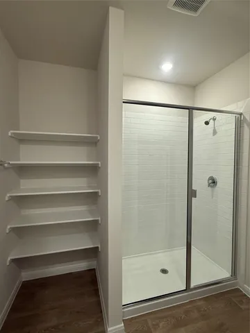 a bathroom with a glass shower door