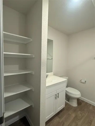 a bathroom with a toilet a sink and vanity