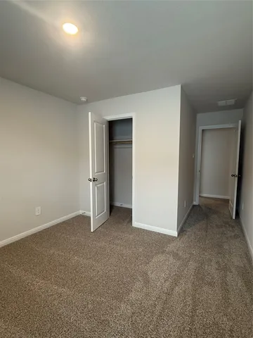 an empty room with closet area