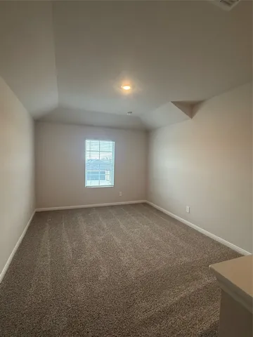 a view of an empty room and a window