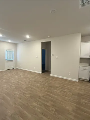 a view of an empty room with closet and a window