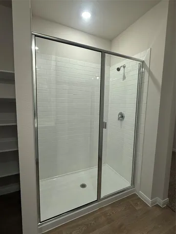 a bathroom with a glass shower door