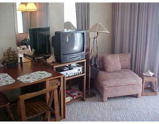 3938 Surfside, Unit 1322 Corpus Christi, TX 78402 - Photo 2 of 5 a living room with furniture a flat screen tv and a fireplace