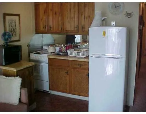 a kitchen with a refrigerator and a stove