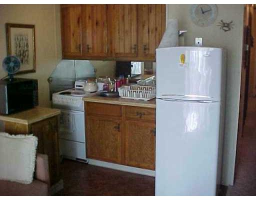 3938 Surfside, Unit 1322 Corpus Christi, TX 78402 - Photo 3 of 5 a kitchen with a refrigerator and a stove