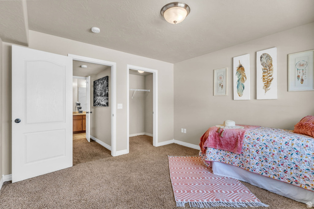 1136 West Spencer Road, Unit Y203 Pleasant Grove, UT 84062 - Photo 19 of 26 Bedroom featuring a walk in closet and light carpet