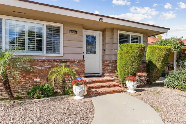 front view of a house with potted plants