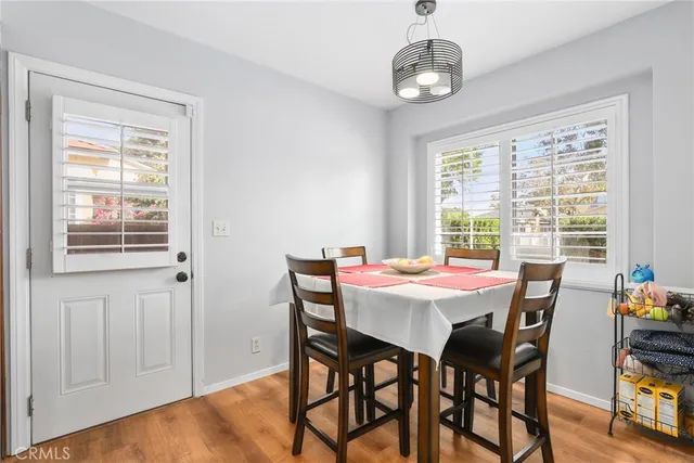 a dining room with furniture a chandelier and wooden floor