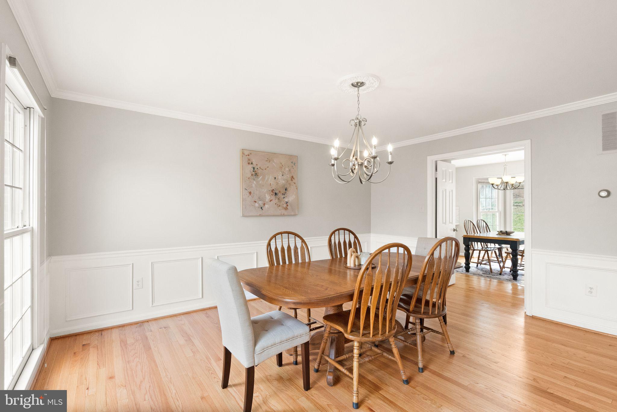 6833 Compton Heights Circle Clifton, VA 20124 - Photo 12 of 81 a view of a dining room with furniture wooden floor and chandelier