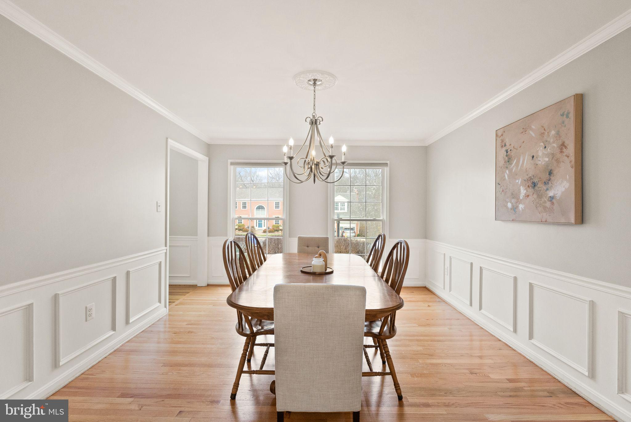6833 Compton Heights Circle Clifton, VA 20124 - Photo 14 of 81 a view of a dining room with furniture a chandelier and wooden floor