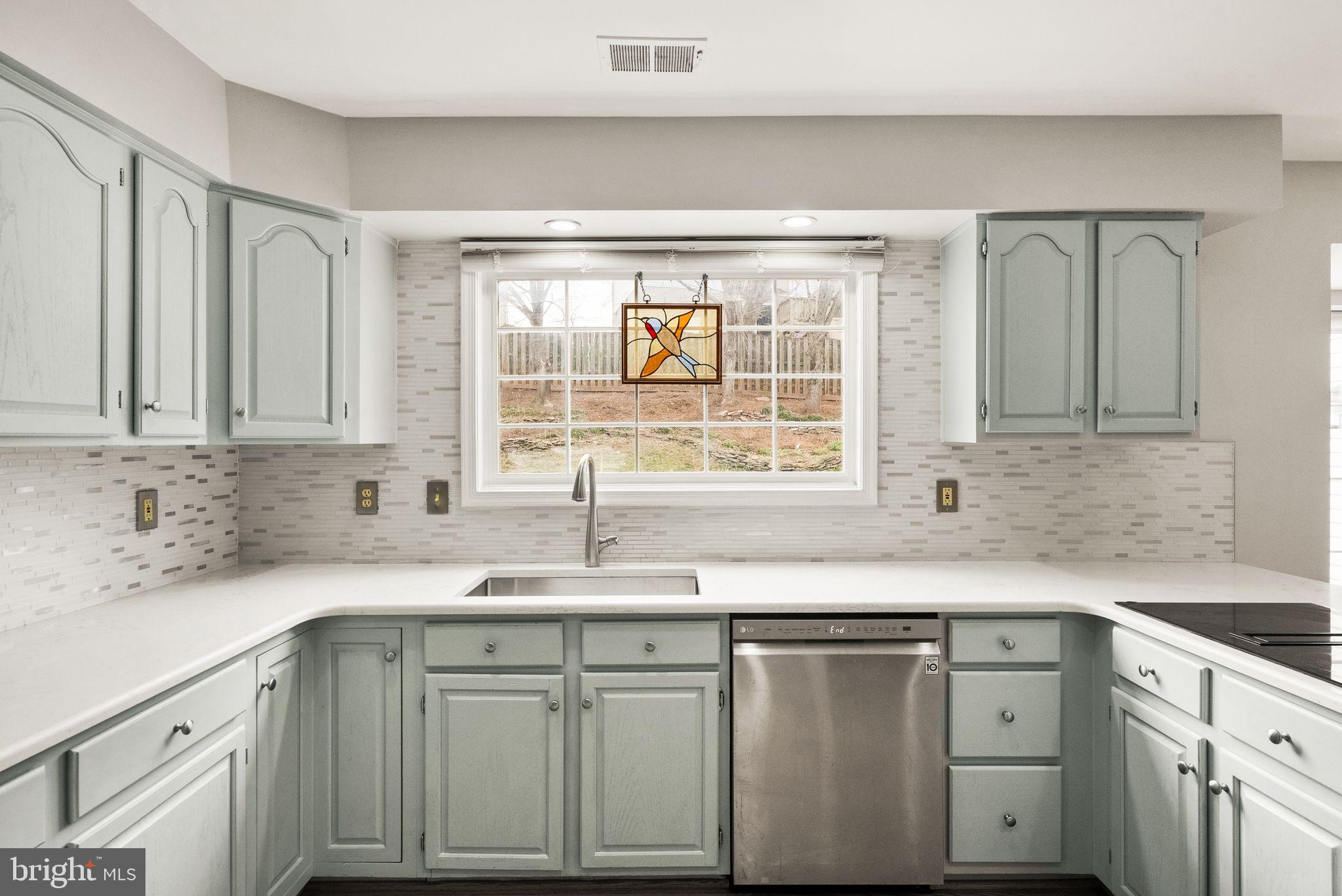 6833 Compton Heights Circle Clifton, VA 20124 - Photo 24 of 81 a kitchen with stainless steel appliances granite countertop white cabinets sink and window