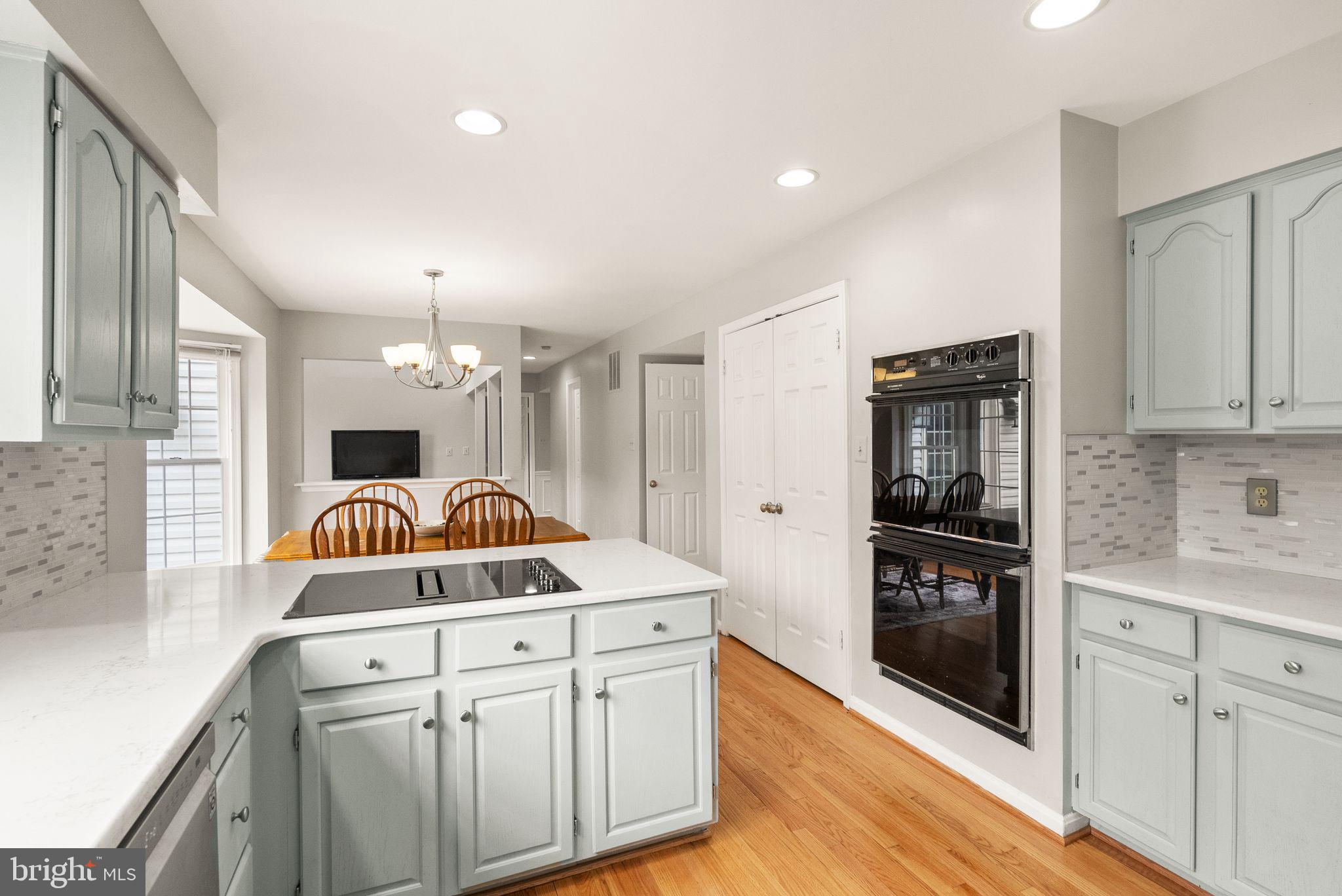 6833 Compton Heights Circle Clifton, VA 20124 - Photo 25 of 81 a kitchen with cabinets and wooden floor