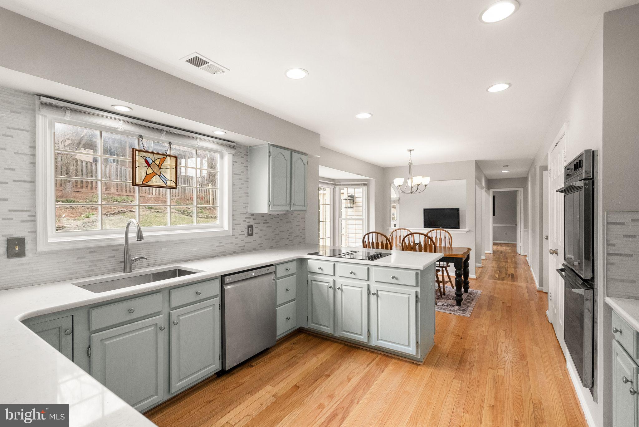 6833 Compton Heights Circle Clifton, VA 20124 - Photo 26 of 81 a kitchen with a sink a counter top space stainless steel appliances and windows