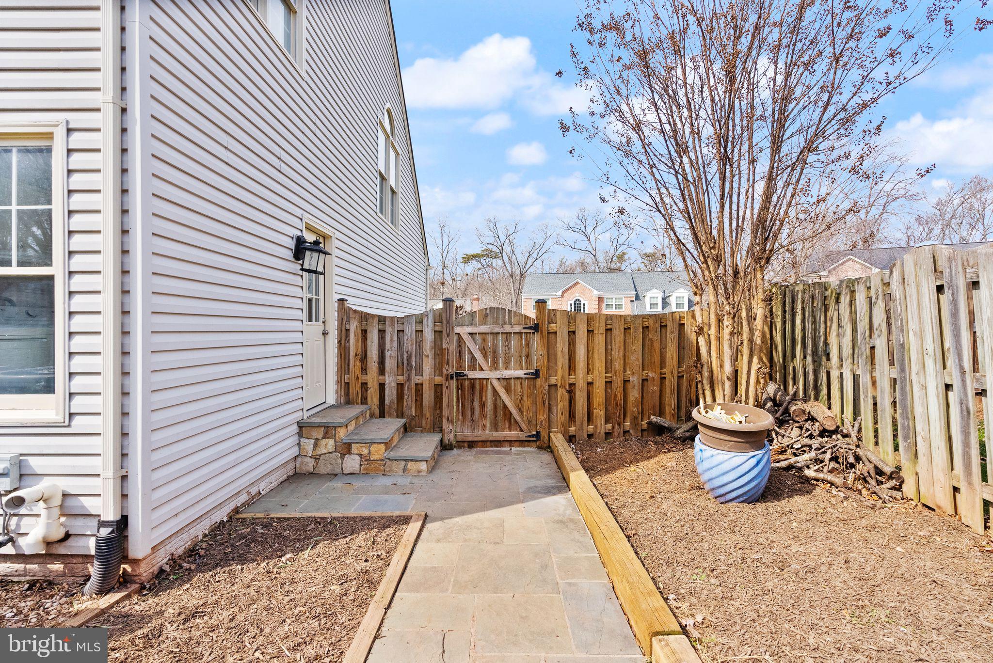 6833 Compton Heights Circle Clifton, VA 20124 - Photo 68 of 81 a view of a patio with a table and chairs and wooden fence