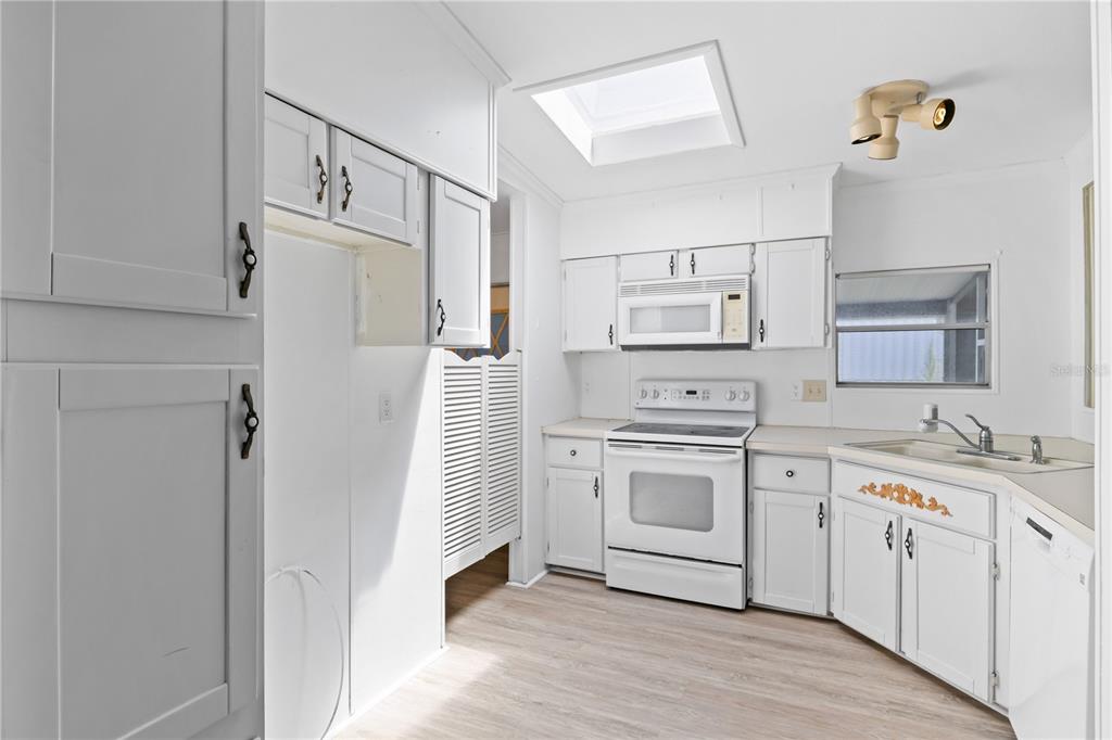 15550 Burnt Store Road, Unit 229 Punta Gorda, FL 33955 - Photo 13 of 40 a kitchen with white cabinets and white appliances