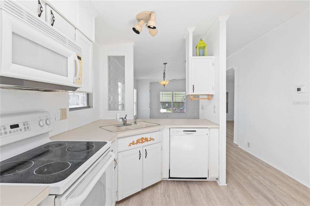 15550 Burnt Store Road, Unit 229 Punta Gorda, FL 33955 - Photo 14 of 40 a kitchen with a sink stove and cabinets