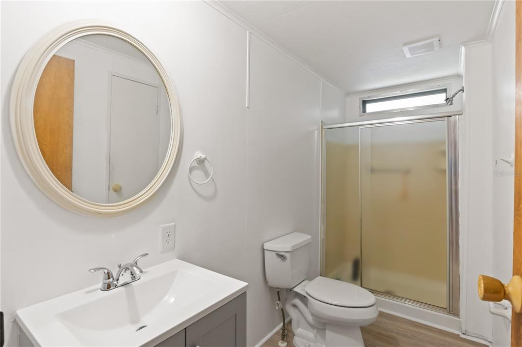 15550 Burnt Store Road, Unit 229 Punta Gorda, FL 33955 - Photo 17 of 40 a bathroom with a sink mirror toilet and vanity