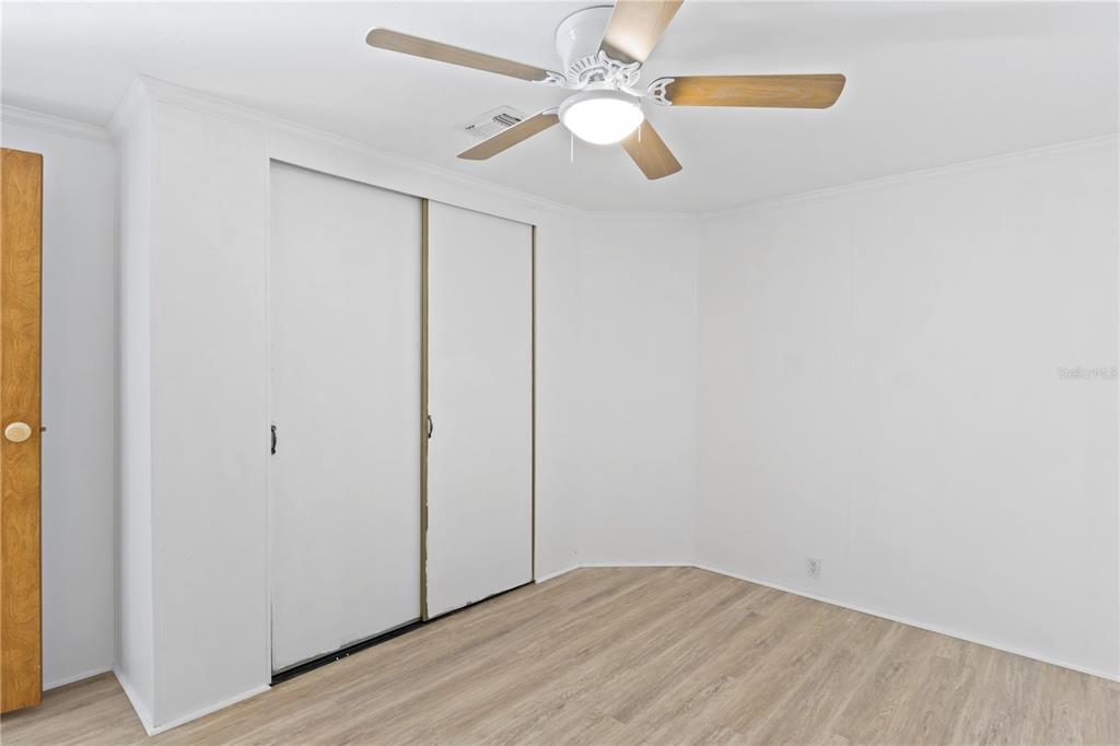 15550 Burnt Store Road, Unit 229 Punta Gorda, FL 33955 - Photo 19 of 40 an empty room with windows and fan