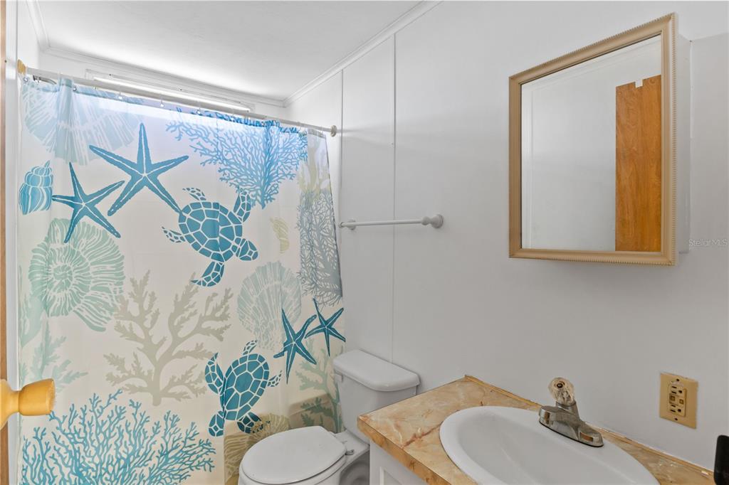 15550 Burnt Store Road, Unit 229 Punta Gorda, FL 33955 - Photo 20 of 40 a bathroom with a toilet sink and mirror