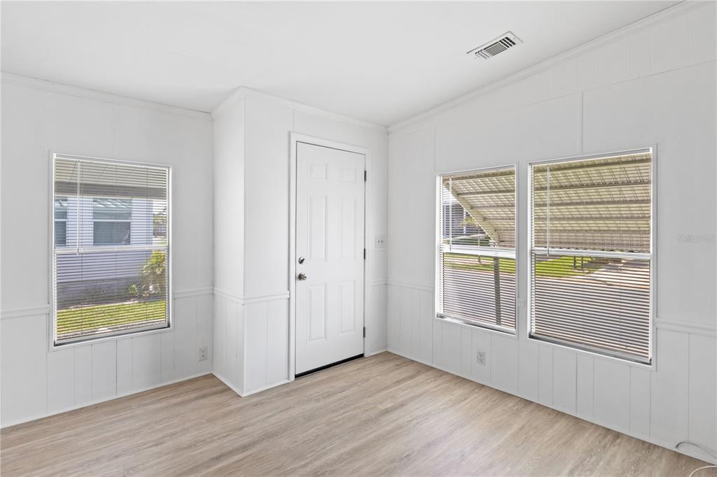 15550 Burnt Store Road, Unit 229 Punta Gorda, FL 33955 - Photo 7 of 40 a view of an empty room with a window and wooden floor