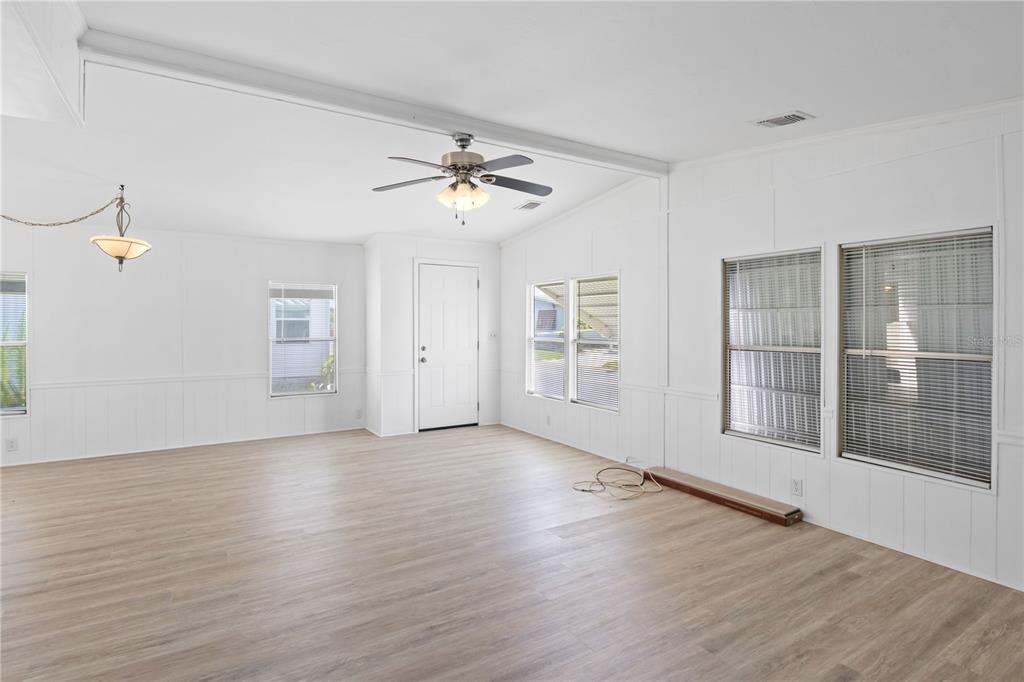 15550 Burnt Store Road, Unit 229 Punta Gorda, FL 33955 - Photo 9 of 40 a view of empty room with wooden floor and fan