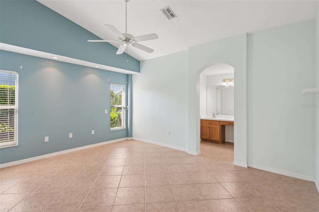 11705 Spindrift Loop Hudson, FL 34667 - Photo 12 of 34 a view of a room with a ceiling fan and carpet