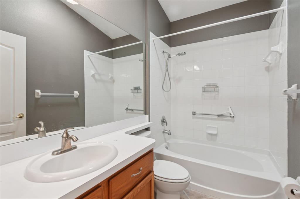 11705 Spindrift Loop Hudson, FL 34667 - Photo 16 of 34 a bathroom with a sink toilet and shower