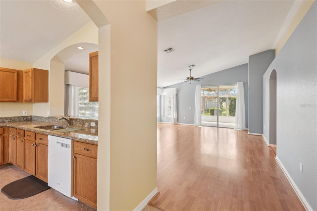 11705 Spindrift Loop Hudson, FL 34667 - Photo 2 of 34 a view of a kitchen cabinets a sink and wooden floor