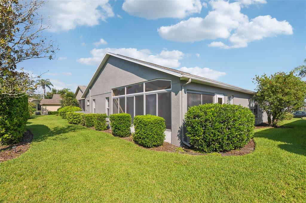 11705 Spindrift Loop Hudson, FL 34667 - Photo 21 of 34 a front view of a house with garden