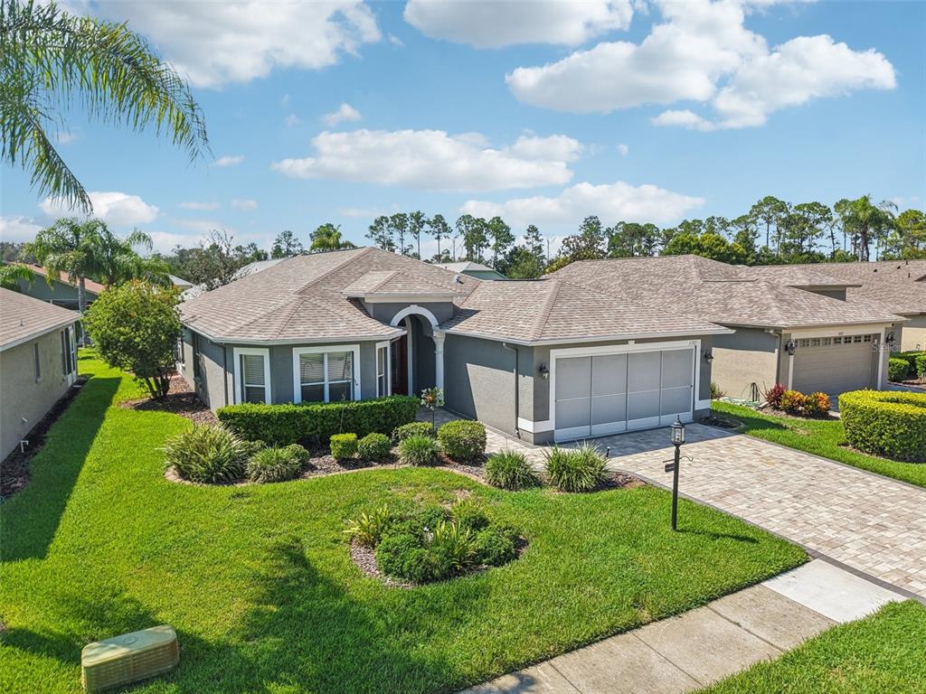 11705 Spindrift Loop Hudson, FL 34667 - Photo 23 of 34 a front view of a house with a garden