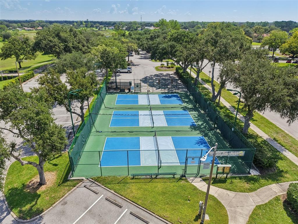 11705 Spindrift Loop Hudson, FL 34667 - Photo 28 of 34 a view of a tennis ground with large trees