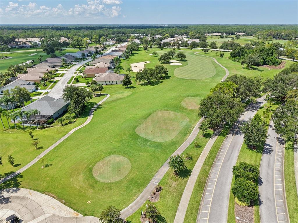 11705 Spindrift Loop Hudson, FL 34667 - Photo 30 of 34 a view of a swimming pool with a yard and outdoor seating