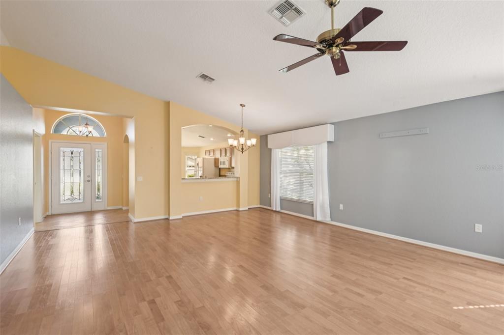 11705 Spindrift Loop Hudson, FL 34667 - Photo 10 of 34 a view of an empty room with window and wooden floor