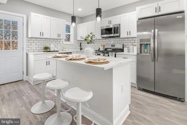 a kitchen with stainless steel appliances a sink and a refrigerator