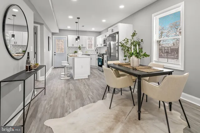 a view of a dining room with furniture and a potted plant