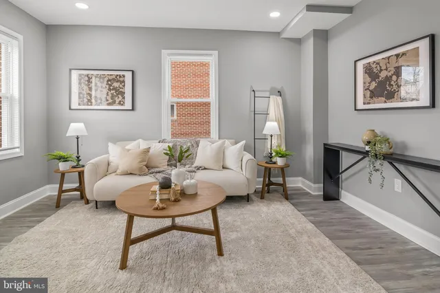 a living room with furniture a rug and a window