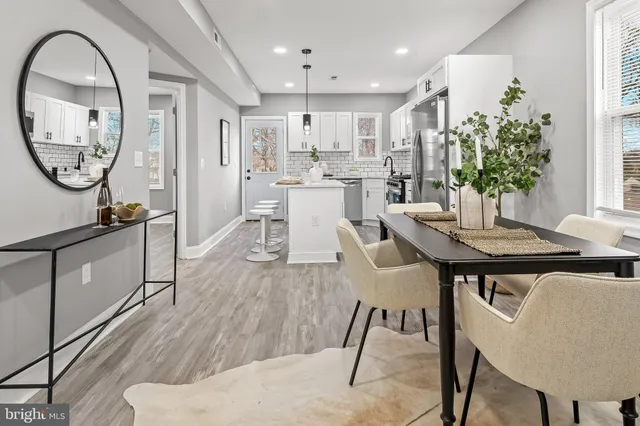 a view of a dining room with furniture and a large window