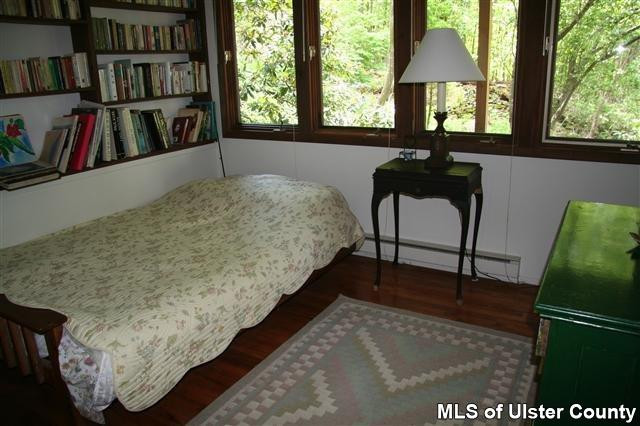 337 John Hewitt Road Roxbury, NY 12474 - Photo 13 of 17 a bed sitting in a bedroom next to a window