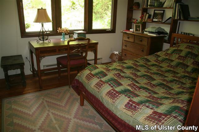 337 John Hewitt Road Roxbury, NY 12474 - Photo 14 of 17 a bed sitting in a bedroom next to a window