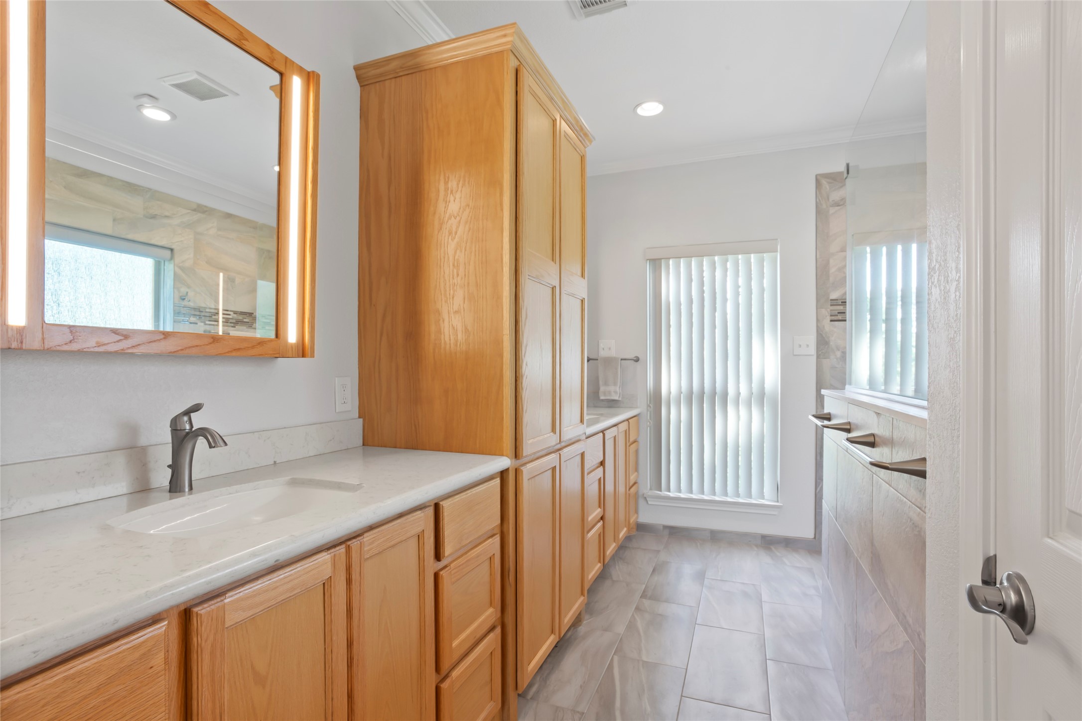 860 FM 517 Road East Dickinson, TX 77539 - Photo 31 of 50 a bathroom with a sink a mirror and a shower